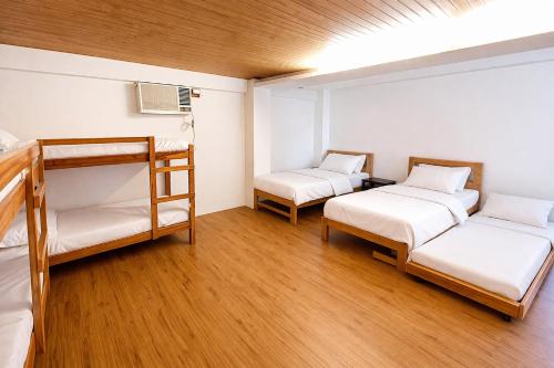 two bunk beds in a room with wooden floors at Taj Resort and Spa in Boracay