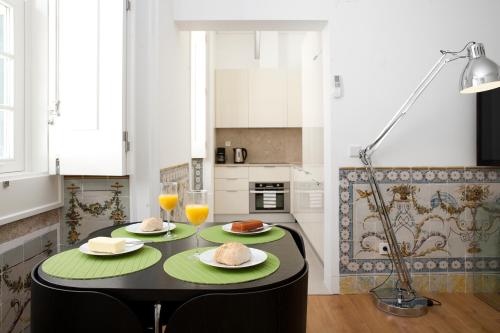 a kitchen with a table with two plates of food on it at LSA Baixa Chiado by Numa in Lisbon