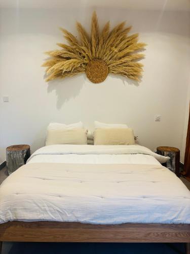 a bedroom with a large bed with a flower on the wall at Villa , Piscine Privée, Jacuzzi in Barbaggio