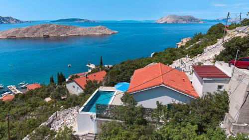 a house on a hill overlooking a body of water at House Vissum by Villas Guide in Lukovo