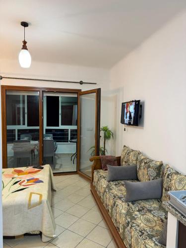 a living room with a couch and a tv at Cabo Dream 51 in Cabo Negro