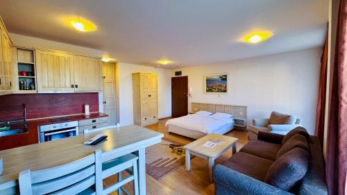 a living room with a couch and a table in a room at студио Пирин in Razlog