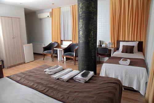 a hotel room with two beds with towels on the bed at garden hill hotel in Istanbul