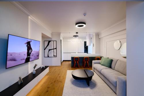 a living room with a couch and a table at Unique by UpTown Apartments in Iaşi