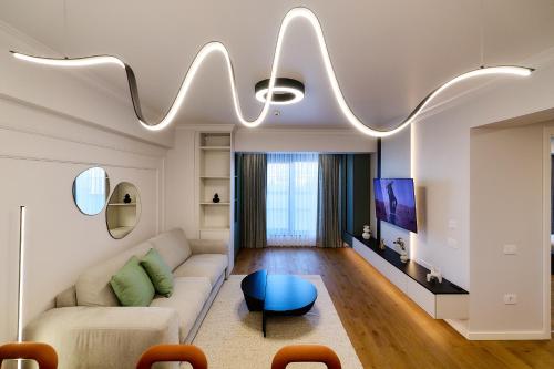 a living room with a couch and a table at Unique by UpTown Apartments in Iaşi