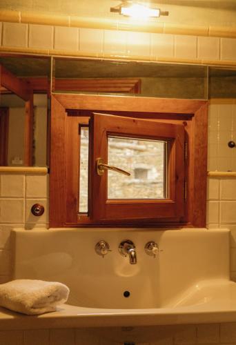 a bathroom with a sink and a window at Mas D'en Roqueta in Aravell