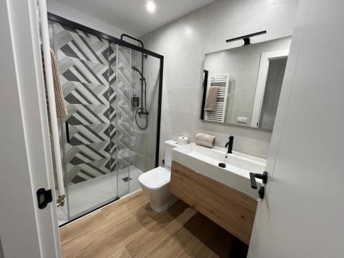 a bathroom with a shower and a toilet and a sink at Raíces in La Alberca