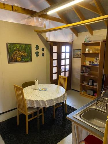 a kitchen with a table and chairs and a sink at Between sea and big mountains in Leirá