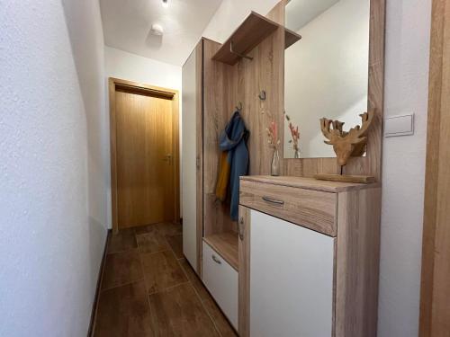 a bathroom with a sink and a wooden wall at Ferienwohnung Heid in Rettenberg