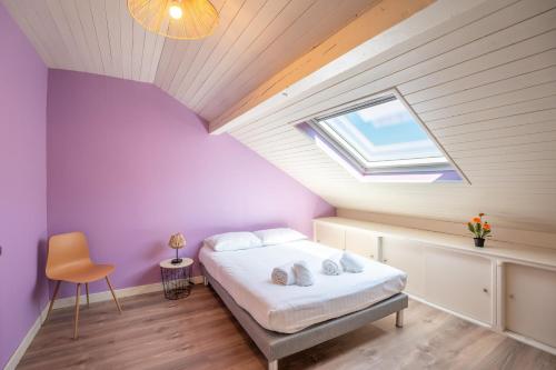 a attic bedroom with a bed and a skylight at Waterfront in Lugrin