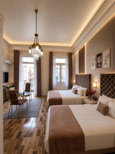 a hotel room with two beds and a desk at Dawn town palace in Cairo