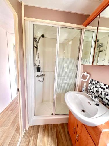a bathroom with a shower and a sink at Hawthorn Self Catering Cottages in Benderloch