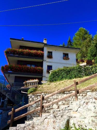 a building with flower boxes on the side of it at B&B Lepetitnid in Valtournenche