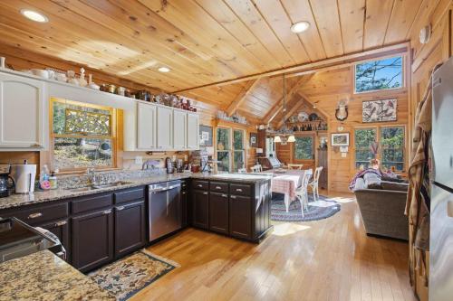 a kitchen with wooden ceilings and a dining room at Not Your Average Bear Hot Tub in Blue Ridge