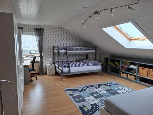 a bedroom with a bunk bed in a attic at Ferienwohnung Charbi in Simmern
