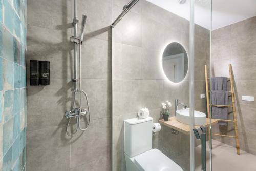 a bathroom with a shower and a toilet and a sink at La Atalaya in Adeje