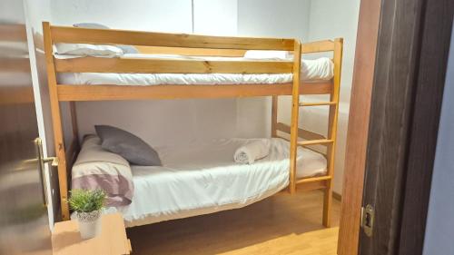 a couple of bunk beds in a room at Casa Senderuela by CARDI Suites in Valdelinares