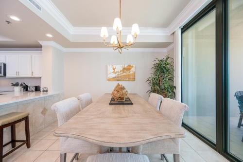 a dining room with a table and chairs at Phoenix IX 707 in Orange Beach
