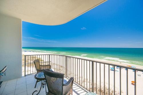 a balcony with chairs and a view of the beach at Phoenix IX 707 in Orange Beach