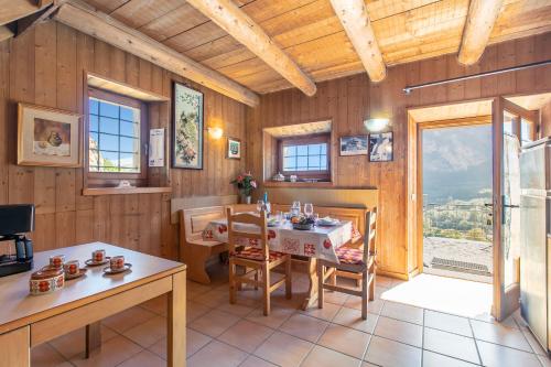 a dining room with a table and chairs and a window at Private Green Oasis - Terrace - Happy Rentals in Tenno