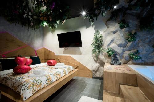 a bedroom with a bed with red apples on it at Navigator Apartment in Bijeljina