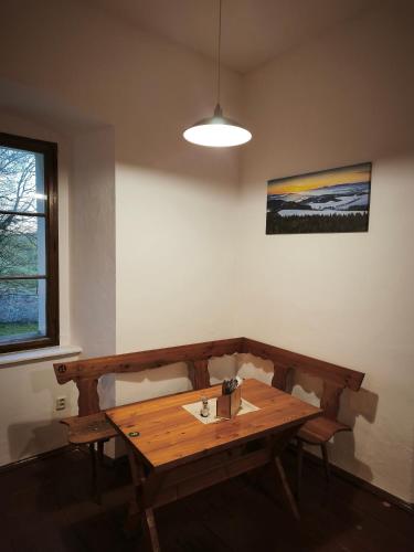 a wooden table in the corner of a room at Zámeček Bischofstein in Teplice nad Metují