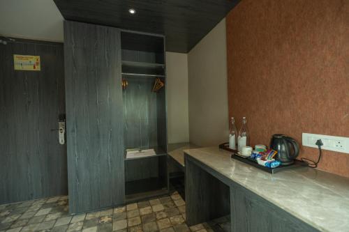 a bathroom with a counter with a shower in it at Hotel Tea County in Dibrugarh