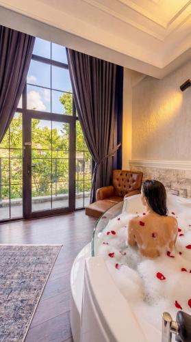a woman sitting in a bath tub in a room at WM Cappadocia in Nevşehir