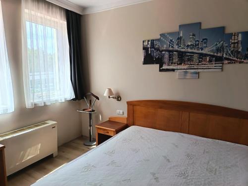 a bedroom with a bed and a large window at alma713 apartman in Zalakaros