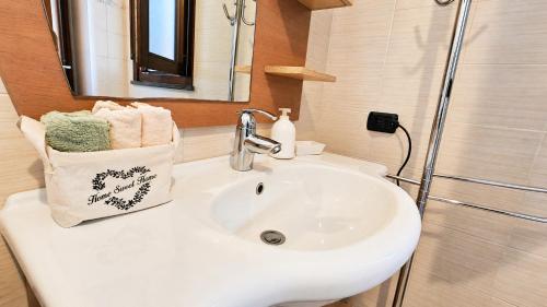 a bathroom with a white sink and a shower at Casa Are in Oristano