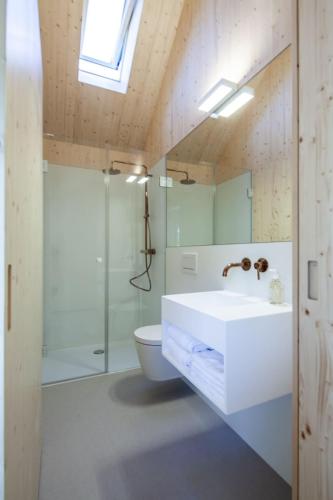 a bathroom with a white sink and a toilet at Tiny House Amélie in Bonndorf im Schwarzwald