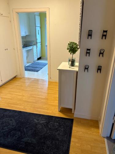 a living room with a table and a kitchen at Two rooms and kitchen in central Uddevalla in Uddevalla