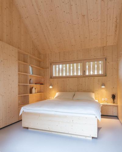 a bedroom with a bed in a wooden room at Tiny House Amélie in Bonndorf im Schwarzwald