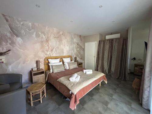 a bedroom with a bed and a stone wall at Résidence Alba in Bonifacio