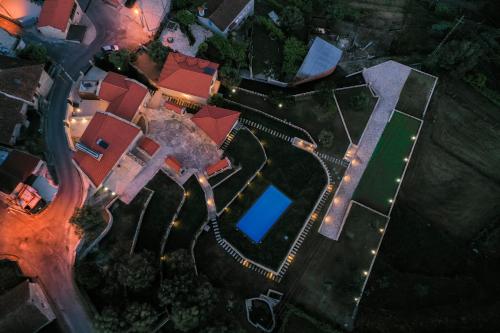 an overhead view of a house with a pool at night at Casas de Selim in Arcos de Valdevez
