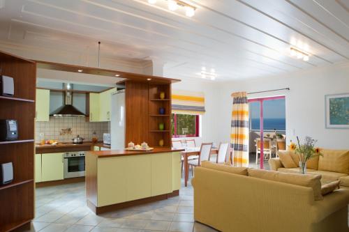 a kitchen and living room with a couch and a table at Exanthia Villas in Exanthia