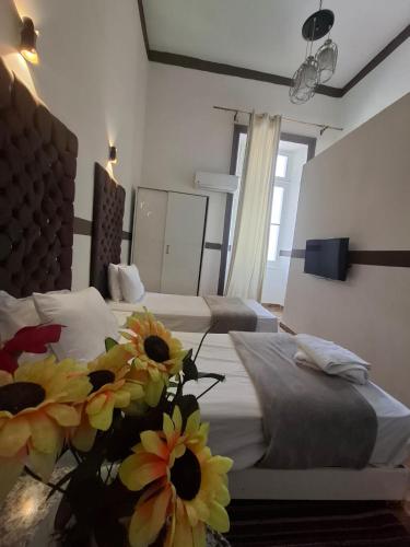 a hotel room with two beds with flowers on it at Lavida ve lv et in Cairo
