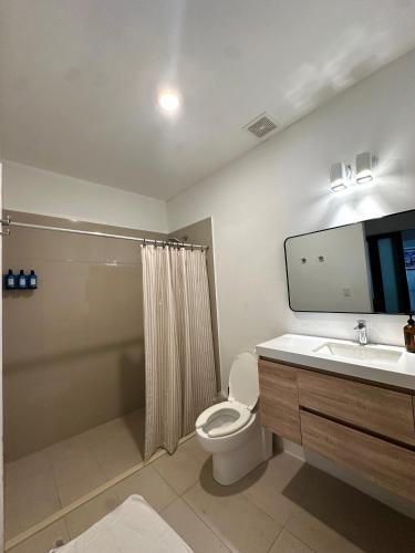 a bathroom with a toilet and a sink and a shower at La Estadia in San Juan