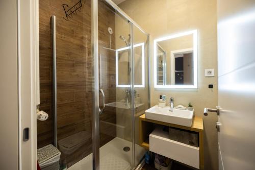 a bathroom with a glass shower and a sink at Liman 5 Riverside 209 i 109 with Free Private Parking in Novi Sad