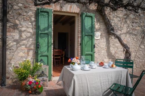 a table with a white table cloth and flowers on it at Preseglie Lake Garda in Desenzano del Garda
