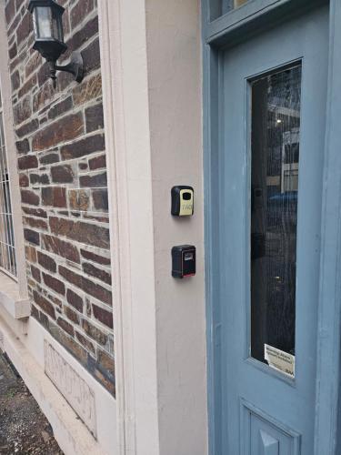 a blue door with a mailbox next to a brick wall at Eden - Franklin 6 in Adelaide