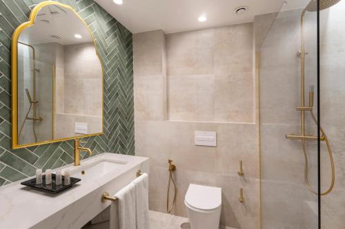 a bathroom with a shower and a sink and a toilet at Vincci Albayzin in Granada