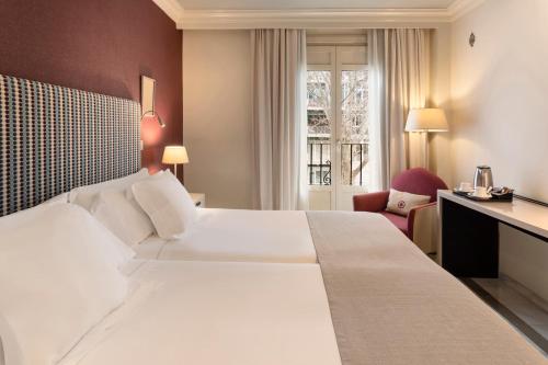 a large white bed in a hotel room at Vincci Albayzin in Granada