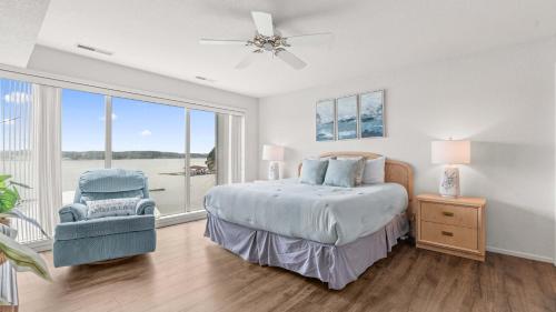 a bedroom with a bed and a large window at By The Lake Resort Access in Lake Ozark