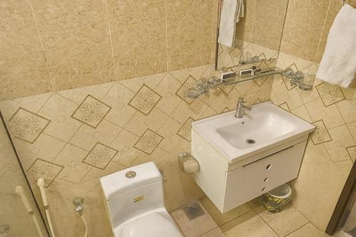 a bathroom with a toilet and a sink at Sapphire Stays Hotel And Restaurant in Peshawar
