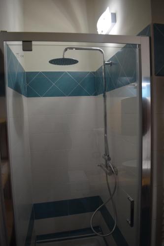 a bathroom with a shower with a glass door at Il Loft Arona Centro, Le Dimore del Corso in Arona