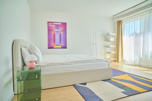 a bedroom with a bed and a glass table at Central rooftop apartment with AC and city view in Basel