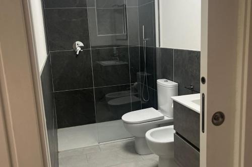 a bathroom with a toilet and a glass shower at La Finestra sul Mare - Goelba in Chiessi