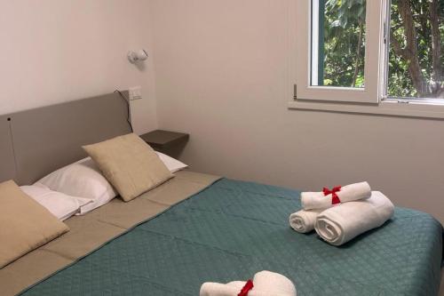 a bedroom with a bed with towels on it at La Finestra sul Mare - Goelba in Chiessi