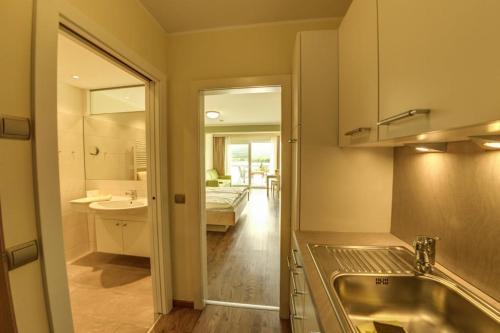 a bathroom with a tub and a sink and a mirror at Seepark Drobollach in Drobollach am Faaker See